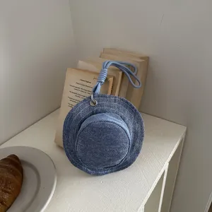 Stylish blue denim hat shaped handbag and compact coin purse with durable strap.
