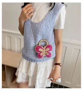 Chic butterfly acrylic crossbody bag with gold chain and sparkly pink glitter wings for women.