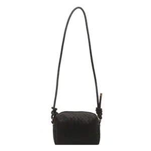 Black woven crossbody shoulder bag for women, soft leather-like texture with knot strap.