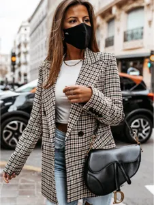 Close-up detail of women autumn retro houndstooth blazer jacket street fashion style shot.