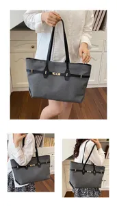 Detail shot of grey vintage large-capacity shoulder tote bag with black handles and metal buckle.