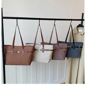 Detailed view of large-capacity shoulder tote bag hanging on rack showing texture and metal lock.