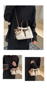 Detailed view of vintage colorblock bucket bag with cute bear pendant and shoulder strap.