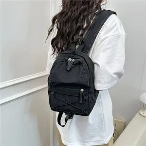 Casual black mini backpack detail view, lightweight travel daypack and school bag for women.