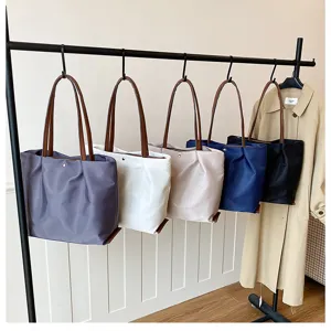 Solid color casual nylon tote bag for women, large capacity stylish shoulder bag for daily commute.