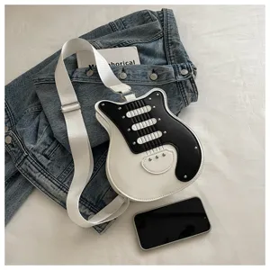 Detailed view of the trendy guitar-shaped crossbody bag in black and white contrast design with studs.