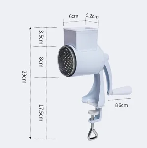 Manual rotary cheese grater and nut grinder with multi-functional drum blades and secure clamp.