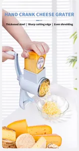 Detailed view of hand crank cheese grater showing stainless steel drum and grating process.