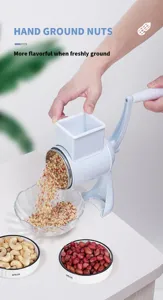 Manual nut grinder detail showing fresh peanut powder dropping into glass bowl neatly.
