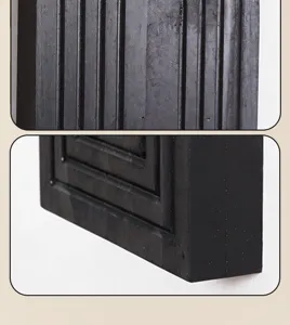 Black wooden wall shelf detail close up showing vertical lines and edge texture profile.