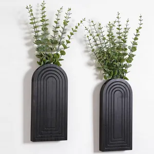 Modern black wooden wall hanging planters with green eucalyptus plants for boho home decor.