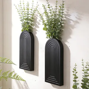 Modern black arched wooden wall hanging planter with green artificial plants for home decor.