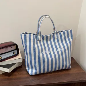 Blue and white striped canvas tote bag detail, featuring clear large capacity and dual handles.