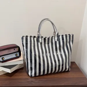 Black and white striped tote bag showing large capacity, vintage style and detailed texture design.