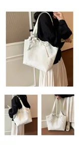 Close-up detail of casual star print canvas tote bag with bow and star charm for daily use.