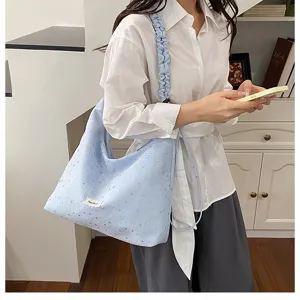 Detail shot of the light blue star print tote bag, showcasing soft fabric and cute strap.
