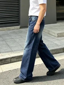 Retro dark blue denim jeans streetwear outdoor detail shot showing casual straight leg fit