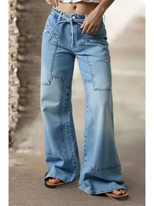 Light blue wide-leg denim pants featuring trendy patchwork seams and a stylish tie waist.