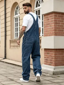 Men's denim overalls detail shot showing back pocket design and loose fit styling in street view.