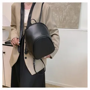 Stylish minimalist black leather backpack, casual daily use, trendy small daypack.