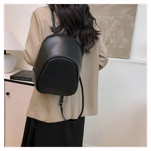 Detail view of a chic minimalist black PU leather backpack worn by a model, versatile casual style.
