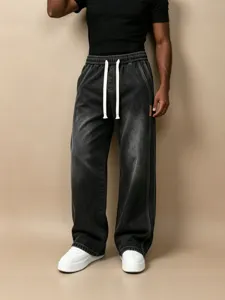 Men's washed black wide-leg denim jeans with white drawstring elastic waist detail.