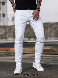 Detail view of men's stretch slim fit distressed white jeans in casual urban street style.