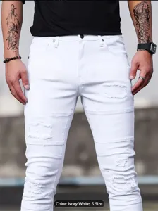 Close-up of men's white ripped stretch slim jeans showing stylish distressed knee details.