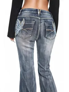 Women's vintage wash flare jeans with butterfly embroidery back view product display