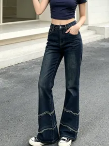 High waist dark blue flare jeans with frayed patchwork cuffs, stylish street style detail.