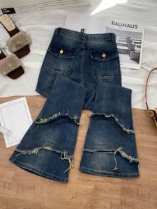 Women high waist dark blue flare jeans with raw edge patchwork design and back pockets.