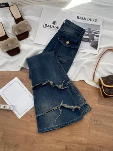 Women dark wash denim flare pants with distressed raw hems, stylish spliced casual jeans.