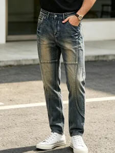 Close-up shot of men's retro distressed denim jeans featuring unique washed texture.