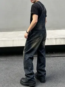 Detailed view of men women loose casual denim overalls, streetwear style, dark wash denim.