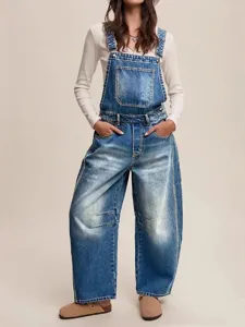 Stylish women's denim overalls featuring a relaxed loose fit and classic blue wash design.