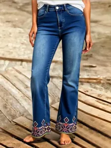 Women's blue denim jeans featuring stylish geometric embroidered hems, high waist and slim fit.