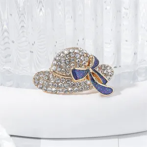 Rhinestone hat brooch detail, sparkling crystal and blue bow lapel pin accessory close up