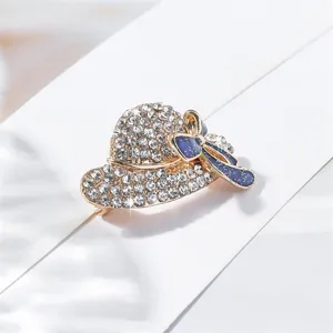Close-up detail of rhinestone hat brooch with blue bow sparkling crystals refined accessory