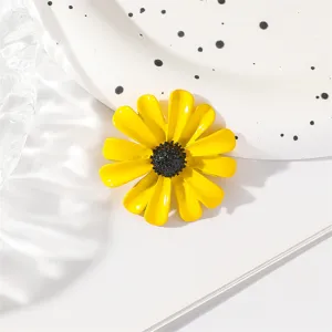 Enamel yellow daisy flower brooch detail, chic lapel pin and stylish clothing accessory item.