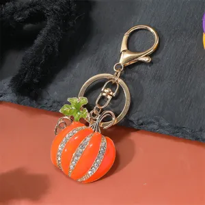 Detailed view of rhinestone pumpkin keychain, glossy enamel finish, alloy lobster clasp.