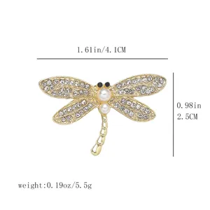 Close-up detail of the exquisite gold-tone rhinestone and pearl dragonfly brooch, showing size.