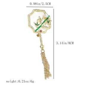 Exquisite Chinese style fan brooch detail, featuring bamboo pattern, pearl and tassel accent.