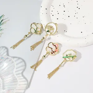 Detail view of Chinese style enamel plum orchid bamboo chrysanthemum tassel brooch pin for qipao.