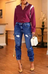 Detail shot of women's distressed cargo jeans, high waist, elastic cuffs, casual denim pants.