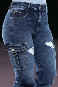 Close-up detail of women's dark blue denim cargo jeans with side pockets and distressed knees.