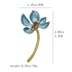 Detailed shot of the elegant enamel lotus brooch with pearl and crystal accents. Size and weight.