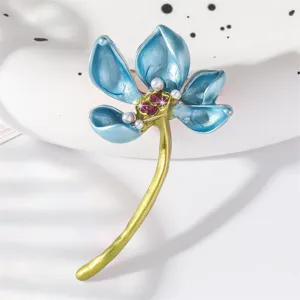 Elegant blue enamel lotus flower brooch with pearls and rhinestones, perfect vintage clothing accessory.