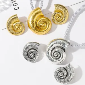 Detailed close-up of alloy conch seashell pendant necklace and earrings jewelry set.