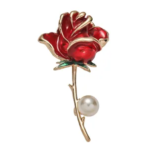 Exquisite red rose enamel brooch detail, featuring gold-plated stem and elegant pearl accent.