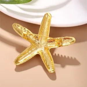 Gold starfish brooch back detail showing secure pin clasp, ocean jewelry accessory close-up
